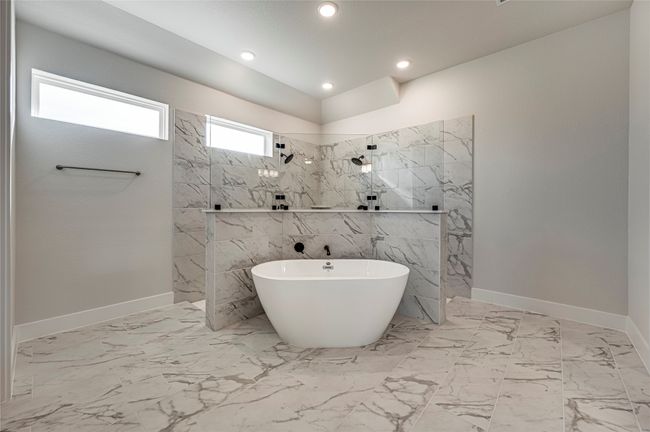 Bathroom featuring baseboards, a freestanding tub, recessed lighting, a marble finish shower, and marble finish floor | Image 13