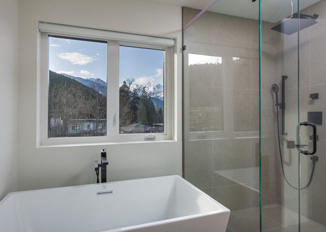 Full bath with a freestanding tub, a mountain view, a shower stall, and a sink | Image 21