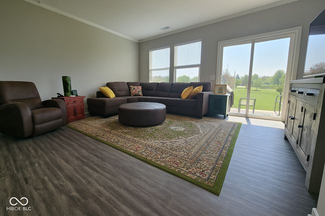 living area featuring dark wood-type flooring and ornamental molding | Image 10