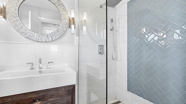 Bathroom with vanity and tiled shower | Image 5