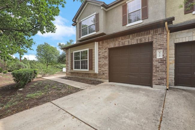 View of front of property with brick siding, stucco siding, driveway, and an attached garage | Image 4