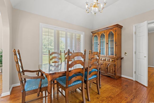 Dining space featuring a chandelier and light wood-style floors | Image 5