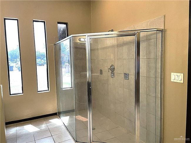 Full bathroom with tile patterned floors, a shower stall, and plenty of natural light | Image 15