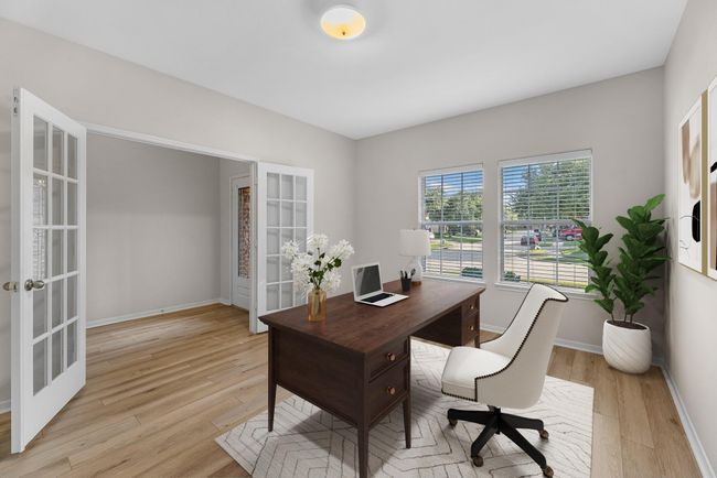 The home office features French doors, beautiful floors, large windows that give a fresh feel, this space promotes focus and creativity. Virtually staged to show furniture placement. | Image 4