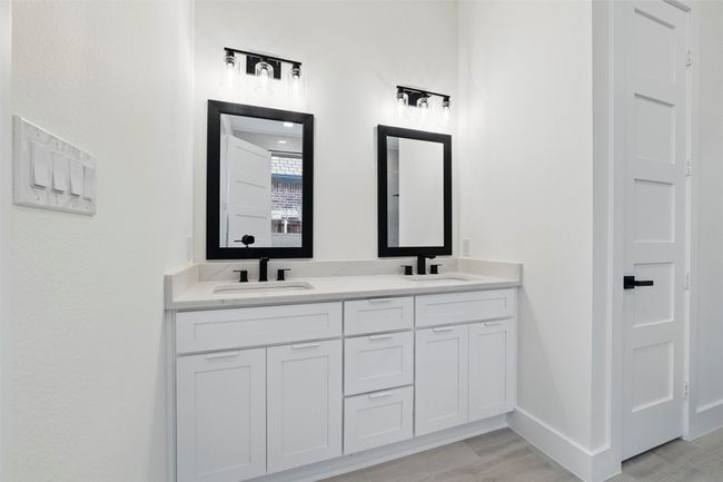 Bathroom with baseboards, double vanity, and a sink | Image 32