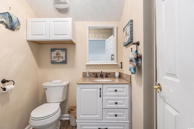 Half bath with toilet, vanity, and baseboards | Image 31