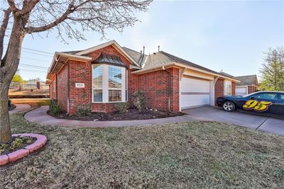 View of front of home with a front yard and a garage | Image 2