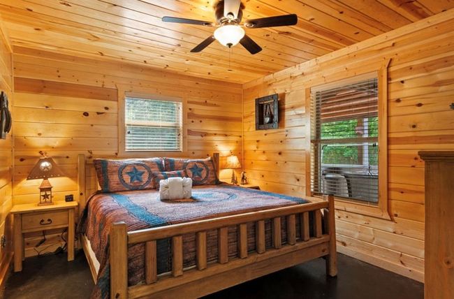 Bedroom featuring wood ceiling, wooden walls, and ceiling fan | Image 20