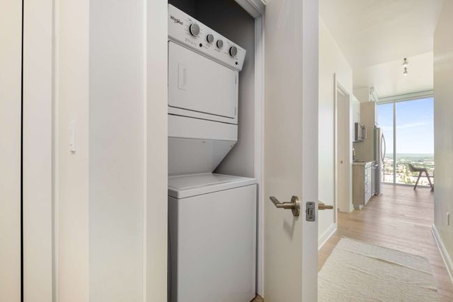 The home's in-unit laundry is conveniently located in the entry hallway, just outside the primary bedroom. | Image 32