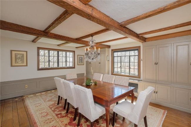 Formal dining room, random width wide board oak floors, beamed ceiling, wall of built-ins, wianscoting | Image 12