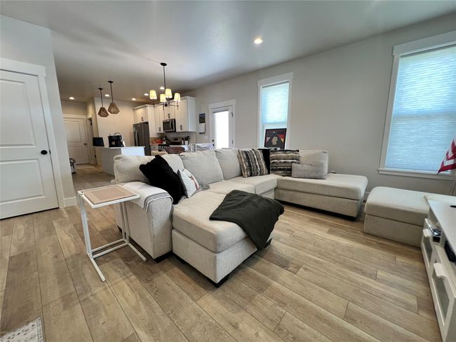 Living room featuring a chandelier, light wood-type flooring, healthy amount of natural light, and recessed lighting | Image 8