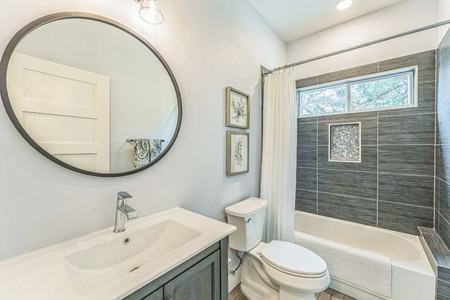 Secondary Bathroom featuring shower / tub combo, vanity, and toilet | Image 22