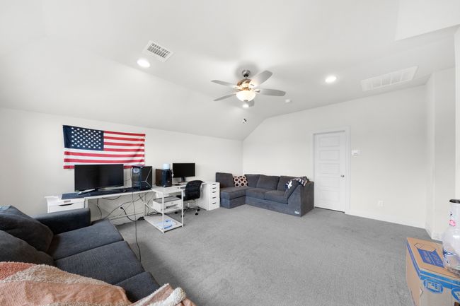 Living area featuring carpet floors, ceiling fan, vaulted ceiling, an office area, and recessed lighting | Image 16