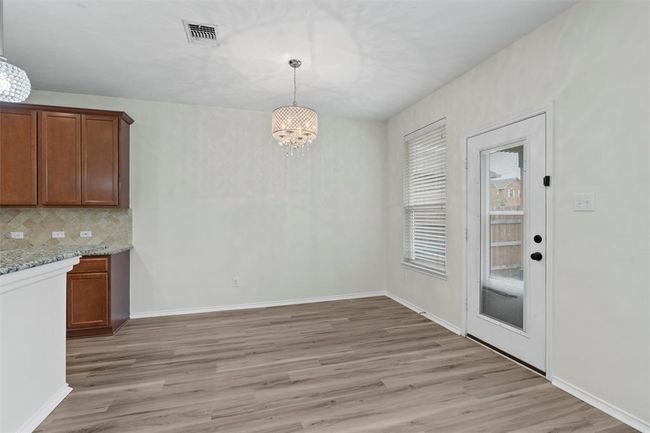 Dining Room leads to covered back patio. | Image 8