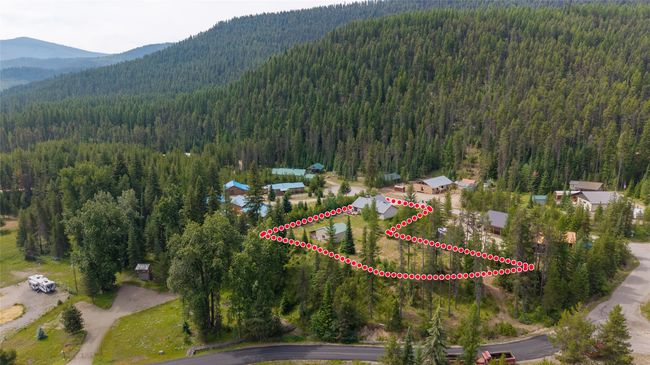 Aerial view of property's location with property boundaries highlighted and a mountainous background | Image 4