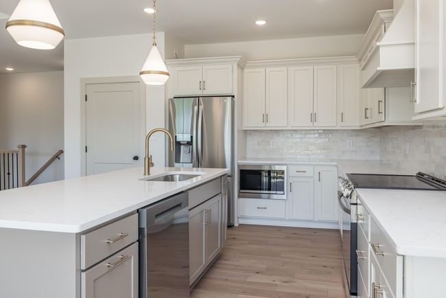 SPACE: Cabinets, countertops, and pantry. Tucked away microwave, custom wood hood, beautiful finishes, upgraded appliances | Image 11