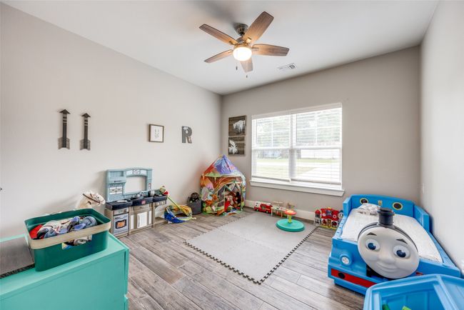 Game room featuring a ceiling fan and wood finished floors | Image 8