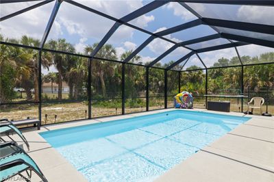 View of swimming pool featuring a lanai and a patio | Image 2