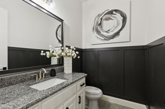 Bathroom with vanity, a decorative wall, wainscoting, and tile patterned floors | Image 15