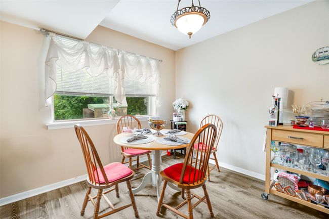 Dining room with wood finished floors and plenty of natural light | Image 8