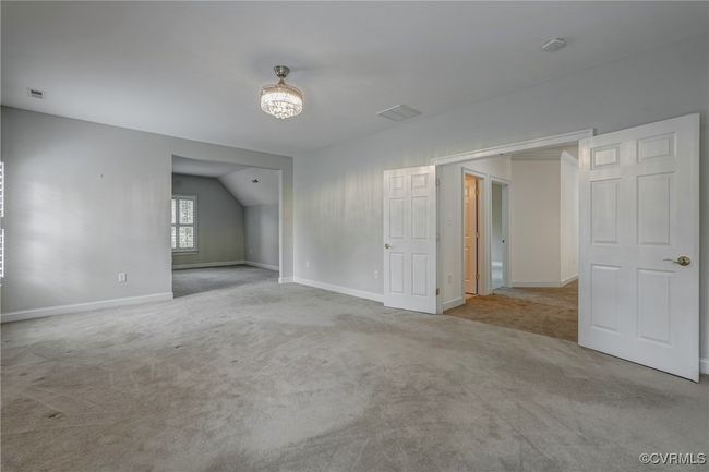 Spacious primary suite featuring a cozy sitting area. | Image 31