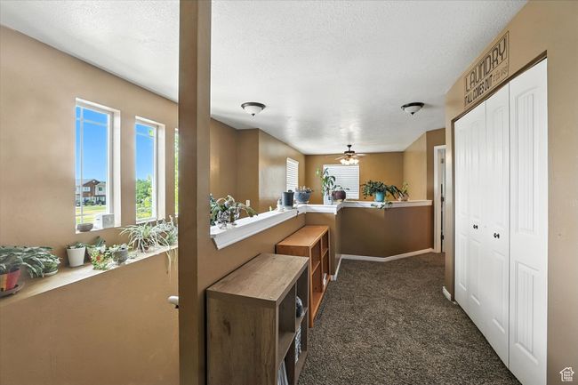 Welcome area with a textured ceiling and ceiling fan | Image 15
