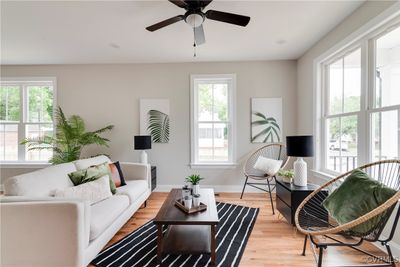 Living room with light hardwood / wood-style flooring and ceiling fan | Image 2