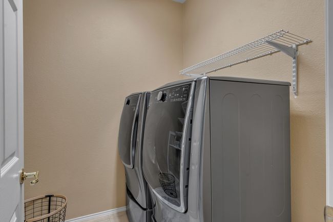 Washroom featuring washing machine and clothes dryer | Image 5