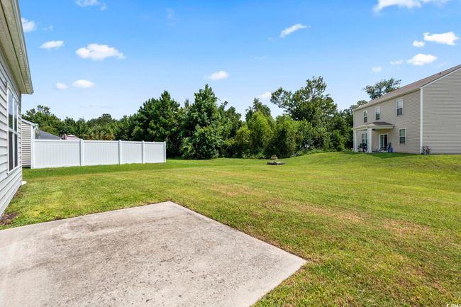 View of yard featuring a patio and view of wooded area | Image 24