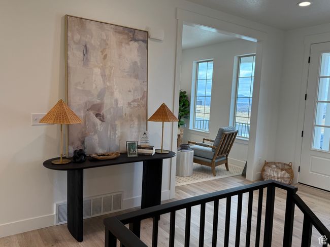 Entryway featuring visible vents, wood finished floors, a wealth of natural light, and baseboards | Image 10
