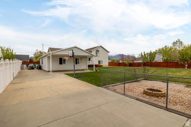 View of front of house with fence private yard, driveway, and a front lawn | Image 4