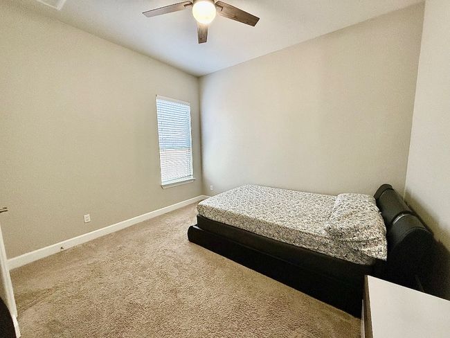 Bedroom featuring baseboards, carpet flooring, and a ceiling fan | Image 19