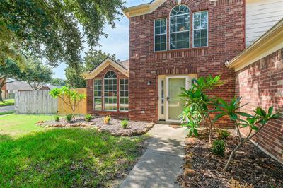 Charming and inviting exterior with a well-manicured lawn and mature trees. | Image 2