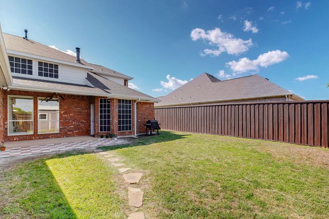 View of yard featuring a fenced backyard and a patio | Image 33