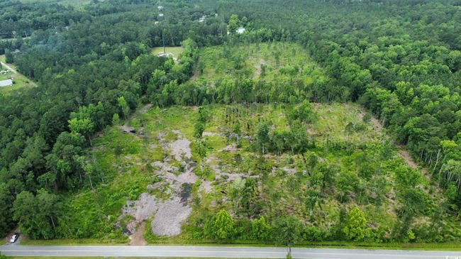Aerial overview of property's location with a heavily wooded area | Image 6