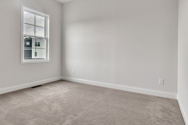 Guest bedroom just off the kitchen area with 10 ft ceiling, trendy ceiling fan and lighting. | Image 14