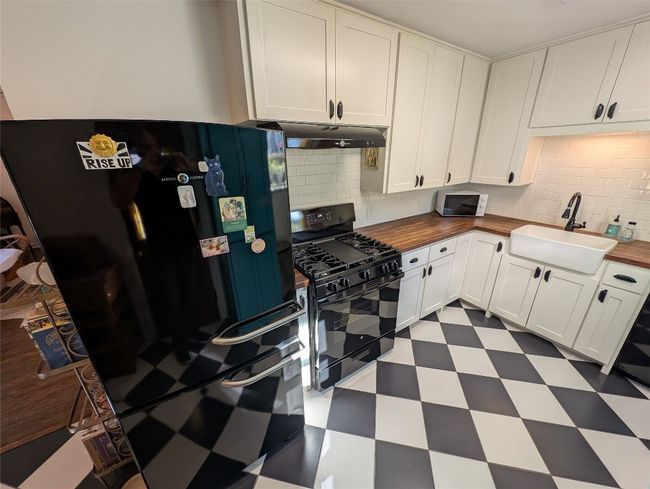Kitchen with farmhoue sink adn deep refrigerator | Image 6