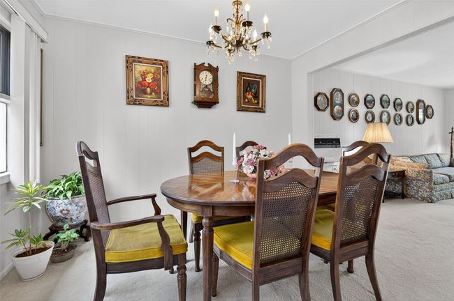 Carpeted dining room featuring a chandelier | Image 4