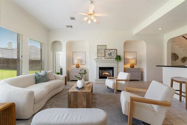 The inviting living area features a cozy gas fireplace and two media niches—ideal for relaxing or entertaining. | Image 5