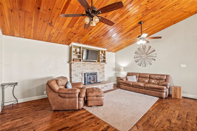 Hand scraped wood floors, pine ceiling and wood burning fireplace with insert | Image 9