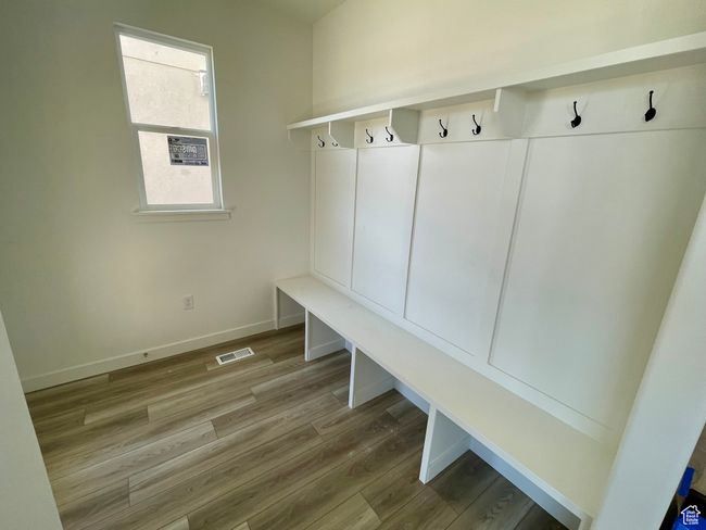 Mudroom with wood finished floors and baseboards | Image 6