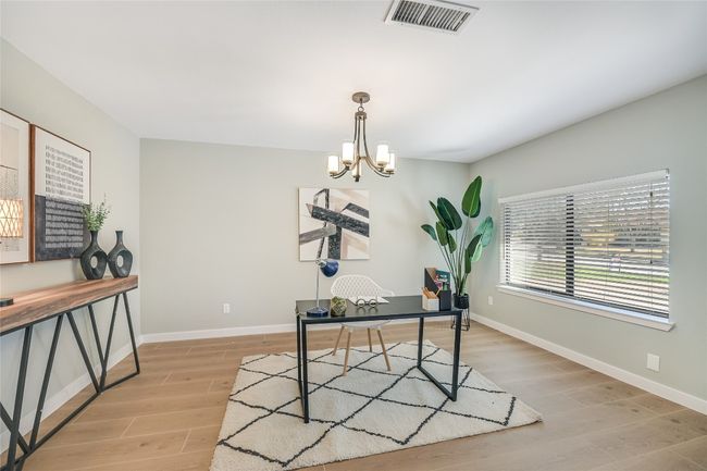 Formal dining room, staged as Home office with light wood-style tile floors, window and a chandelier | Image 5