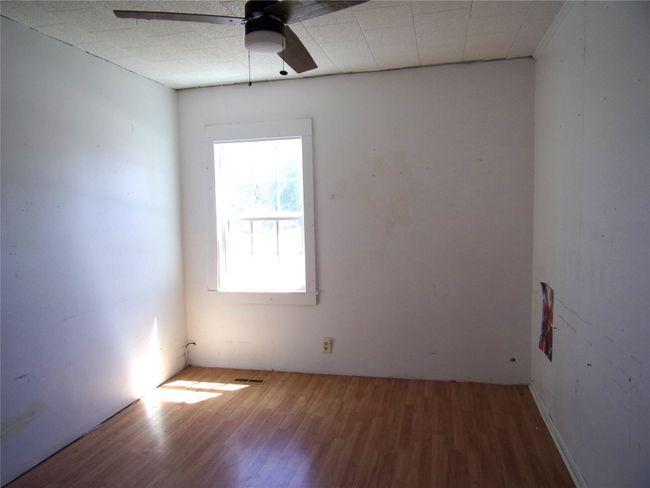 Spare room featuring visible vents, ceiling fan, and wood finished floors | Image 12
