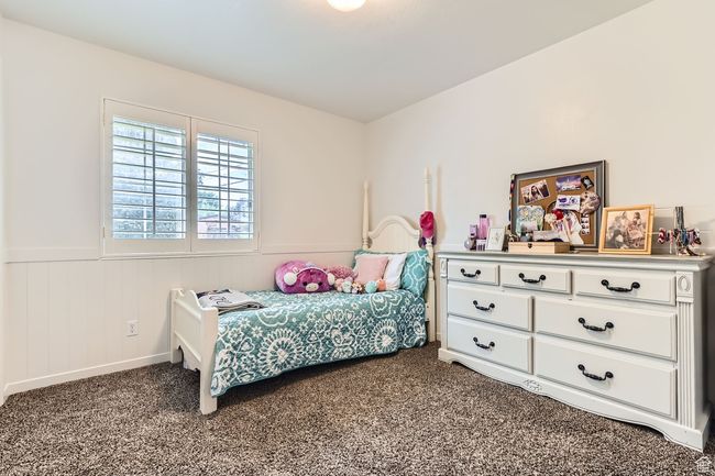 Carpeted bedroom with wainscoting | Image 14