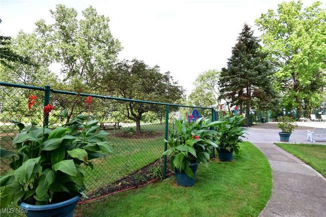 Surrounding community featuring a lawn and fence | Image 37