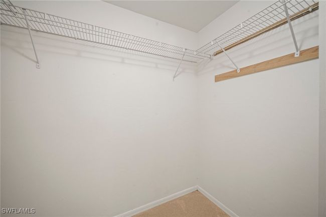 Walk in closet with carpet floors | Image 14