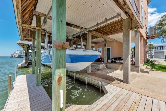 The covered boat lift easily supports a 19-foot jet boat weighing in at around 2, 400 pounds. Whether you're heading out for water sports or a calm evening cruise, this setup makes it simple to launch and dock right from your own back deck. | Image 31