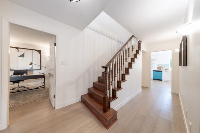 Staircase featuring baseboards and wood finished floors | Image 24
