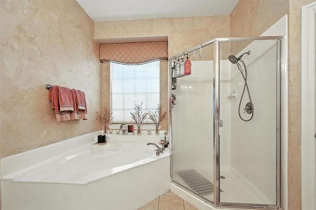 Full bath with a shower stall, a bath, and tile patterned floors | Image 14