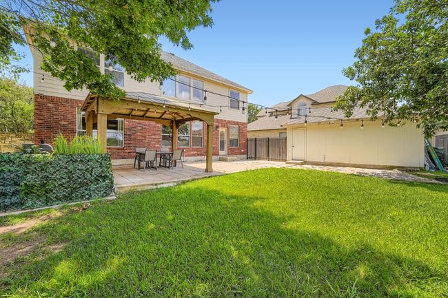Rear view of house with brick siding, a patio, and a gazebo | Image 32